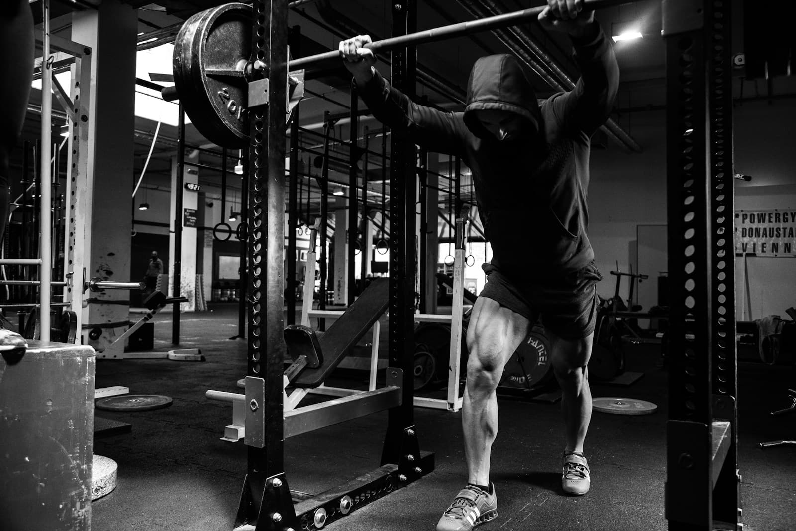Lifter unracking a loaded barbell